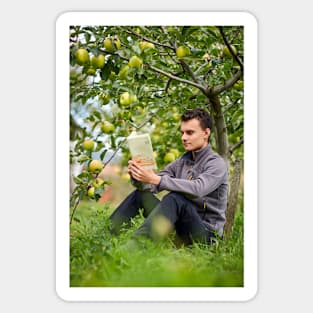 Teenager reading a book in the orchard Sticker